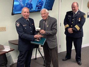 Don Haist receives award from Mayor Doug Malanka as Chief Rob Bowman watches. Wayne Lowrie/Recorder and Times