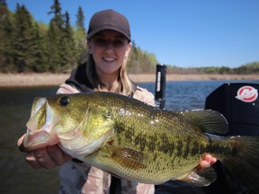 Shelby Gustafson with a nice largemouth caught just after ice out in the back of a shallow bay. Photo by Jeff Gustafson