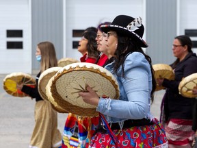 Hand drummers help lead the way during the May 5 Honour Walk to draw attention to missing and murdered Indigenous women and girls on Red Dress Day in Cochrane.