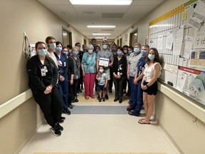 Registered Nurse Bryce Cherry and his colleagues on Inpatient Surgery pose for a picture after being presented with the 2022 Leslie Burt-Manary RN Leadership Award.