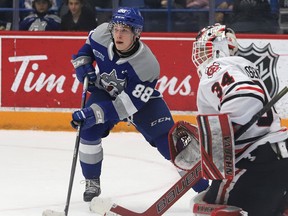 David Goyette, of the Sudbury Wolves, hovers in front of goalie Josh Rosenzweig, of the Niagara IceDogs, during OHL action at the Sudbury Community Arena in Sudbury, Ont. on Friday April 1, 2022.