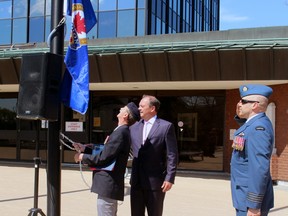 22 Wing/CFB North Bay commanding officer Col. Richard Jolette salutes as Royal Canadian Legion Ontario Command President Garry Pond and North Bay Mayor Al McDonald raise the Legion flag at North Bay City Hall, Friday.
PJ Wilson/The Nugget