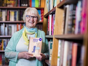 Author Denyse Mouck poses with a copy of her book "Broken Chair" along rows of books inside Chapters in Belleville, Ontario where the author was signing copies during a meet the author event on Sunday. ALEX FILIPE
