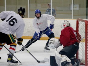 Matthew Mazzotta, centre, prepares to shoot on goaltender Logan Carr during a scrimmage at the Greater Sudbury Cubs' prospect camp at Gerry McCrory Countryside Sports Complex in Sudbury, Ontario on Saturday, May 14, 2022.