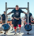 With the fastest time for the yoke and farmer-carry medley, Nathan Edwards farmer-carried 265 pounds per hand for 35 feet, then is seen here with the 700lb yoke across his shoulders which competitors had to also carry for 35 feet.   BOB DAVIES