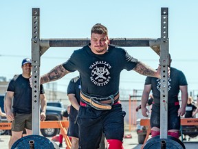 With the fastest time for the yoke and farmer-carry medley, Nathan Edwards farmer-carried 265 pounds per hand for 35 feet, then is seen here with the 700lb yoke across his shoulders which competitors had to also carry for 35 feet.   BOB DAVIES