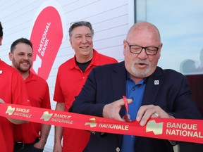 Mayor Brian Bigger cuts the ribbon to officially open National Bank’s location in New Sudbury. Mia Jensen