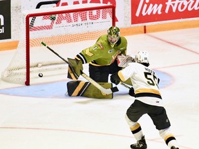 Goaltender Joe Vrbetic of the host North Bay Battalion makes a save against Ben Roger of the Kingston Frontenacs in Ontario Hockey League playoff action last Saturday. The visiting Troops open the Eastern Conference final series Friday night against the Hamilton Bulldogs.
Sean Ryan Photo