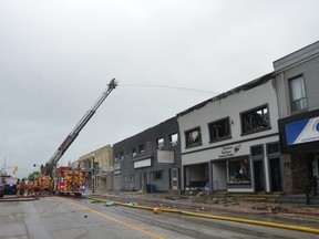 Fire crews continue to pour water on a fire along Hanover's main street late on the morning of Thursday, May 19, 2022.