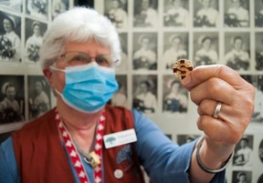 Joan MacDermind, a volunteer for the Stratford General Hospital Archives, holds the pin she received after graduating from the Stratford General Hospital School of Nursing in 1956. After a 40-year nursing career, MacDermid is now one of the caretakers of the hospital's artifacts.  (Chris Montanini/Stratford Beacon Herald)