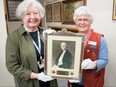 Janette Veal (left) and Joan MacDermid, volunteers with the Stratford General Hospital Archives, hold a photograph of Alexandra Munn, a graduate of the Stratford General Hospital Training School for Nurses in 1913. She was a superintendent of the school from 1919 to 1927 until she was seconded to by the province to set up standardized registration exams for graduating nurses in Ontario. (Chris Montanini/Stratford Beacon Herald)