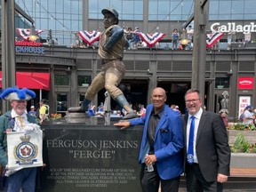 Hall of Fame pitcher and Chicago Cubs legend Fergie Jenkins, a Chatham native, had his statue unveiled outside Wrigley Field on Friday. He's shown with Chatham-Kent Mayor Darrin Canniff, as well as town crier George Sims. (Submitted)