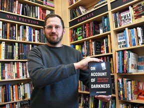 Ian Kennedy holds his new book, On Account of Darkness, inside the Turns and Tales bookstore in downtown Chatham May 10, 2022. Kennedy is also appearing at the store on May 28 for a signing and reading. (Tom Morrison/Chatham This Week)