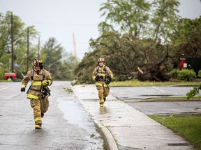 The Stittsville area and many other parts of the Ottawa region were hit by a powerful storm on Saturday, May 21, 2022. Firefighters run up Carleton Cathcart Street.