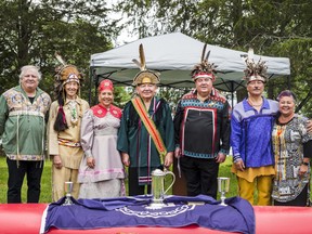 Members of the Tyendinaga Mohawk Council stand in front of a canoe as they commemorate the 238th anniversary since the Mohawk Landing in Bay of Quinte on Sunday in Deseronto, Ontario. ALEX FILIPE