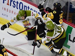 Liam Arnsby and Owen Van Steensel of the visiting North Bay Battalion collide with the Hamilton Bulldogs' Colton Kammerer in their Ontario Hockey League playoff game Sunday night. The Troops host Game 3 of the best-of-seven set at 7 p.m. Wednesday.
Sean Ryan Photo