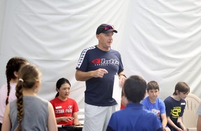 Head pro Richard Bulbring speaks with young students at the Sudbury Indoor Tennis Centre.
