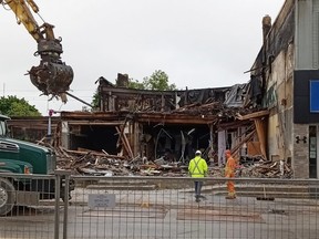 Crews work to clean up Hanover's main street in the aftermath of the Thursday morning fire that destroyed the buildings containing a large rooming house and Fabulous Fashions Consignment Boutique.