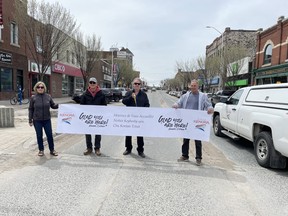 Councillors Sharon Smith, Rory McMillan, Mort Goss and Chris VanWalleghem cut the banner for the 2022 campaign on Main Street on May 19.