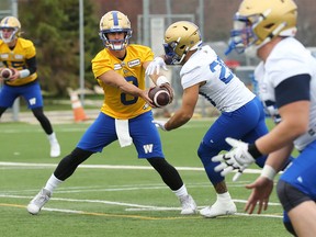 Quarterback Zach Collaros (left) hands off to Brady Oliveira during the first day of Winnipeg Blue Bombers training camp. (Kevin King)