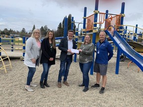 MLA Roger Reid visited Spitzee School on May 16, to present a cheque for $125,000, as part of the Community Facility Enhancement Program grant. The funds have been given by the provincial government to assist the Spitzee Home and School Association with construction of the Spitzee Elementary School Playground.