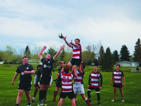Leduc Composite Tiger Caleb Crozier fights for the line out in the first half against Archbishop Jordan, May 18. (Peter Williams)