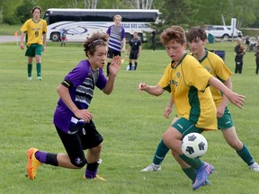 Andre Sousa, left, of the Lo-Ellen Park Knights, defends against a pair of players from the St. Joseph-Scollard Hall Bears during NOSSA junior boys AAA soccer championship action at the Kinsmen Sports Complex in Lively, Ontario on Friday, May 27, 2022. Lo-Ellen won 1-0. Look for more NOSSA coverage in print and online in the coming days.