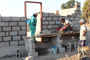 Workers in the Malawian village of Chilumba are seen here laying locally sourced concrete bricks as they build their village's first library.  Submitted photo