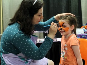 Tealia Carriere of Tickled Teals gives Hailey Gordon, 5, a new look at the East Ferris Trade Show, Saturday.
PJ Wilson/The Nugget