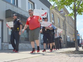 Saugeen Shores Police Service Chief Kevin Zettel, left, and Rob Searson of the Lucknow Kinsmen lead the Walk A Mile in Her Shoes event along Goderich Street in Port Elgin on Sunday, May 29, 2022.