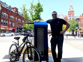 The Stratford City Centre BIA has installed one of two recently purchased bike-repair stations in the city's downtown core as part of an overall effort to make the city more bicycle friendly. Pictured, BIA beautification committee chair James Hough stands next to the repair station at the corner of Wellington Street and Market Place. (Galen Simmons/The Beacon Herald)