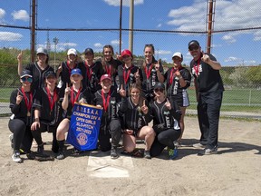 Players and coaches from the Ecole secondaire catholique l'Horizon Aigles girls slo-pitch team celebrate with their championship banner after defeating the Confederation Chargers in the Division A final in Sudbury, Ontario on Tuesday, May 24, 2022. College Notre Dame won the B final.