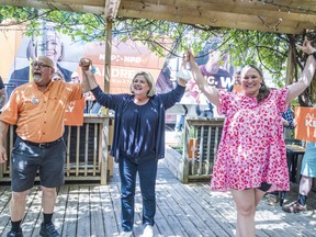 From left, Hastings-Lennox and Addington NDP candidate Eric DePoe, leader of the Ontario NDP Andrea Horwath and Bay of Quinte NDP candidate Alison Kelly raise their hands as they meet and greet supporters during a Tuesday campaign stop at Bermuda in Bloomfield, Ontario. ALEX FILIPE
