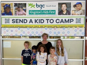 Karen Sutherland stands with BGC South East members at the West End Community Centre, by a donor sign recognizing the more than 100 community members who pledged to support the May campaign.