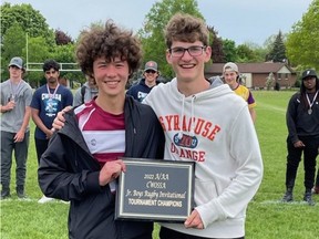 Ricky Tsai (left) and Andrew O’Neail of Holy Trinity Catholic High School hold the plaque their team was awarded after capturing the CWOSSA A/AA junior boys rugby championship.