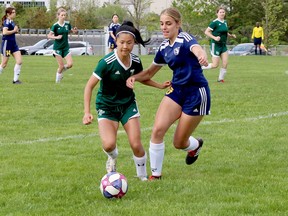 Avery Tullio (15) of the College Notre Dame Alouettes races for the ball with Caroline Hong (6) of the West Ferris Trojans during NOSSA senior girls AAA soccer action at Kinsmen Sports Complex in Lively, Ontario on Friday, May 27, 2022.