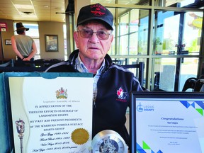 Warburg Pembina Surface Rights Group President Karl Zajes shows the honourific awards he received from Leduc County, the Government of Alberta, and Brazeau County, for his 33 years of leading the group, at a recent Warburg Pembina Surface Rights Group meeting. (Dillon Giancola)