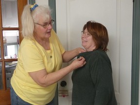 Melody Smillie (R) receives the Ontario Horticultural Association Youth Leader pin from Tryntje Eisen. SUBMITTED