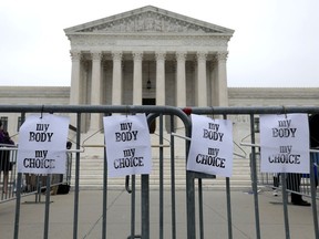 Pro-choice signs hang on a police barricade at the U.S. Supreme Court Building on May 03, 2022 in Washington, D.C.
