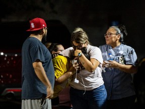 UVALDE, TEXAS - MAY 24: A family grieves outside of the SSGT Willie de Leon Civic Center following the mass shooting at Robb Elementary School on May 24, 2022 in Uvalde, Texas. According to reports, 19 students and 2 adults were killed, with the gunman fatally shot by law enforcement. (Photo by Brandon Bell/Getty Images) *** BESTPIX ***