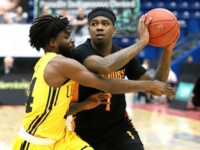 Jaylen Bland of the Sudbury Five is kept in close check by Marcus Ottey of the London Lightning during NBLC action at Sudbury Community Arena on Monday evening.