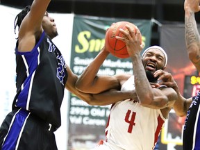 Jabari Craig and Joel Kindred of the Kitchener Waterloo Titans block a shot from  Dexter Williams Jr. of the Sudbury Five during National Basketball League of Canada semifinal action at Sudbury Community Arena on Sunday afternoon. The Titans defeated the Five 122-116.