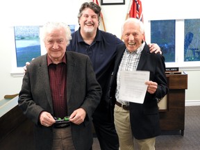 Mayors Pat Sayeau (left). Brett Todd and Doug Malanka celebrate the signing of a partnership agreement held by Malanka. Wayne Lowrie/Recorder and Times