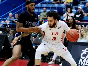 Joel Kindred of the Kitchener Waterloo Titans keeps in tight with Jeremy Harris of the Sudbury Five during National Basketball League of Canada semifinal action at Sudbury Community Arena on Sunday afternoon. The Titans defeated the Five 122-116.