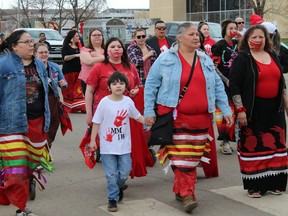 People march down Franklin Avenue for Red Dress Day in Fort McMurray, Alta. on Thursday, May 5, 2022. The day marks a national day of mourning and awareness for missing, murdered and exploited Indigenous peoples (MMEIP). Vincent McDermott/Fort McMurray Today/Postmedia Network