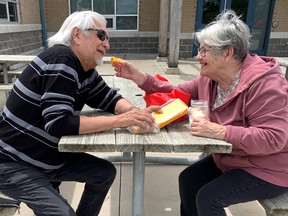 David and Marie LaForce got out of the crowd and found a table where they enjoyed some of their annual gift of bread and cheese after missing the festive day for two years, due to the pandemic.