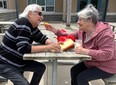 David and Marie LaForce got out of the crowd and found a table where they enjoyed some of their annual gift of bread and cheese after missing the festive day for two years, due to the pandemic.