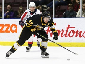 Sarnia Sting's Nolan DeGurse (49) is chased by Windsor Spitfires' Nicholas DeAngelis (22) in the first period at Progressive Auto Sales Arena in Sarnia, Ont., on Sunday, May 1, 2022. Mark Malone/Chatham Daily News/Postmedia Network