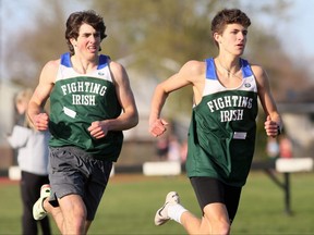 Cole Reinders, right, leads St. Patrick's Fighting Irish teammate JJ Fogarty during the senior boys' 800 metres at an LKSSAA all-comers track and field meet at the Chatham-Kent Community Athletic Complex in Chatham, Ont., on Wednesday, May 4, 2022. Mark Malone/Chatham Daily News/Postmedia Network