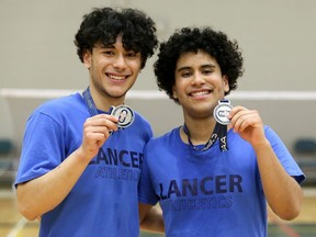 Sebastian Moreno, left, and Nico Moreno of Ursuline celebrate after winning silver medals in the C division for boys' doubles at the OFSAA badminton championship at St. Clair College's Chatham Campus HealthPlex in Chatham, Ont., on Saturday, May 7, 2022. Mark Malone/Chatham Daily News/Postmedia Network